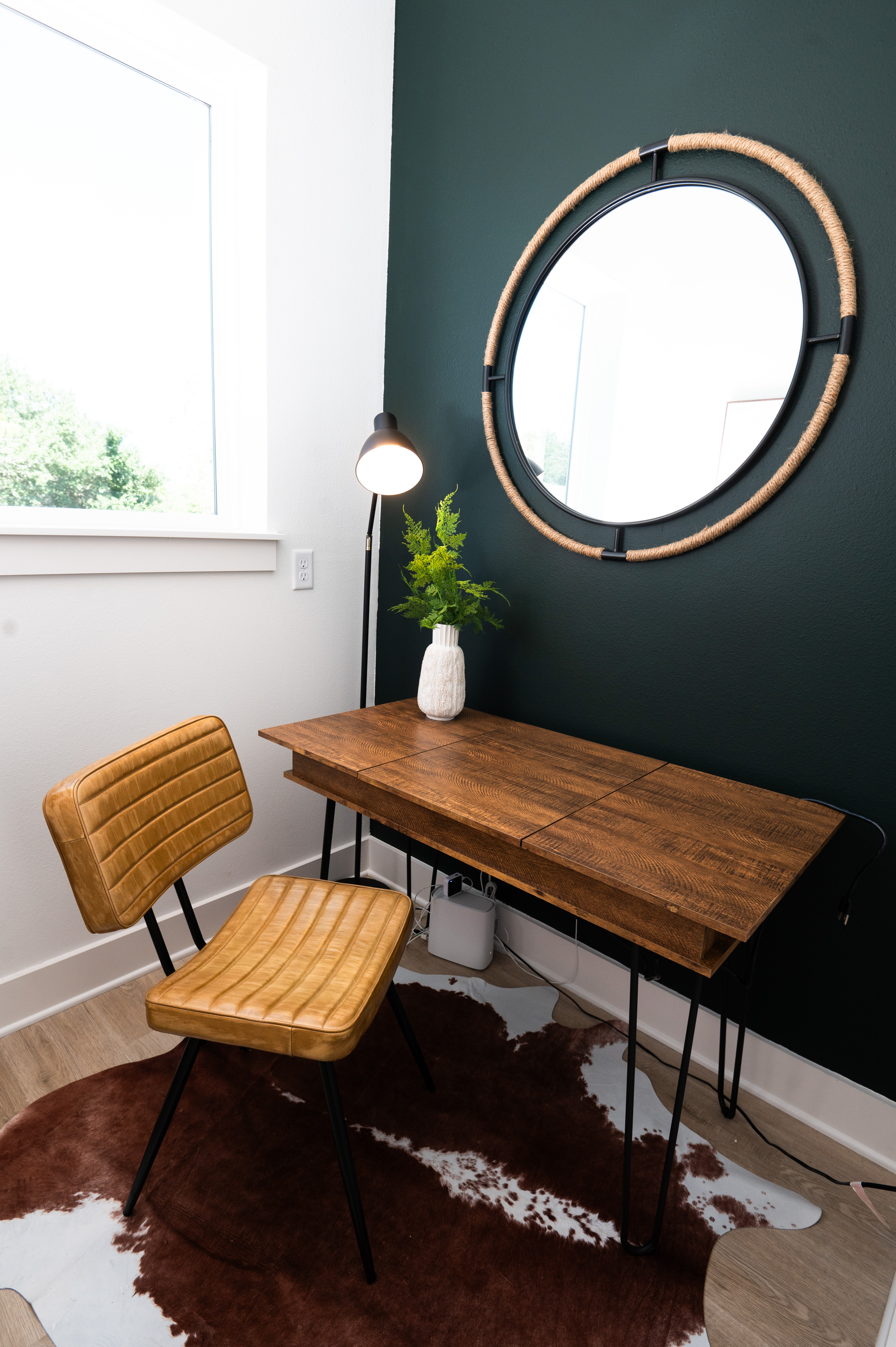 Private office nook with wood desk and dark accent wall